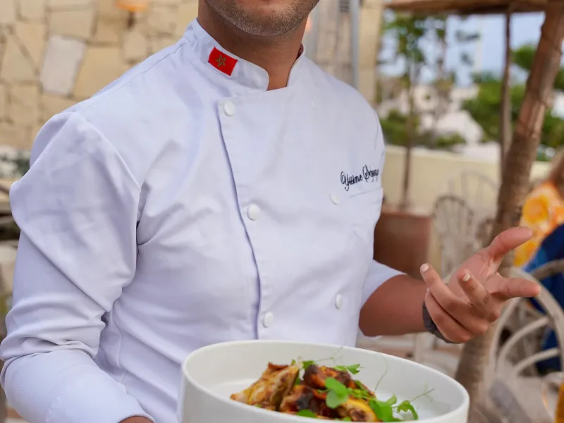 The chef of La Coupole Essaouira Beach presenting a dish